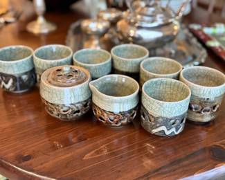 Intricate cream and sugar and coffee cups pottery