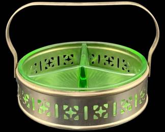423 - Uranium Green Glass Dish w/ Metal Basket (Description): Uranium glass dish insert with metal basket.  The divided glass dish features a green  uranium glass construction and sits within a  decorative pierced metal basket with swing  handle. Measures 4" x 5.25".