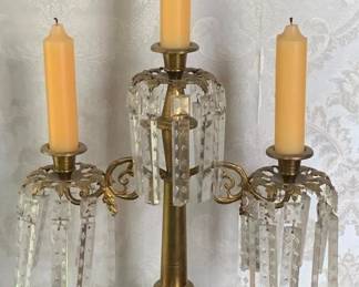 52 - Vintage Brass Candelabra featuring Crystal Prisms (Description): Brass and marble candle holder featuring  three candle cups with hanging crystal  prisms. The ornate brass frame rests on a  marble base. Measures 23 inches tall by 15  inches wide by 5.5 inches deep.