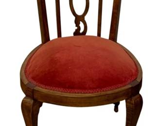 767 - Antique Chair 34"x19"x18" (Description): Antique chair featuring a carved wooden frame  with decorative splat back design and  cabriole legs. The round seat is upholstered  in red velvet with braided trim. Measures 34  inches high by 19 inches wide by 18 inches deep.