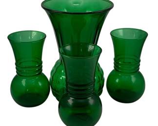 426 - 4 Vintage Green Glass Vases 9"x6" tall (Description): A collection of four green glass vases in  varying styles. The lot includes one larger  vase measuring 9 inches tall and three  smaller vases measuring 6 inches tall. Each  vase features a flared rim and bulbous body design.