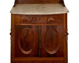 618 - Marble-Top Washstand 35"x29"x17" (Description): Marble-top washstand featuring a shaped  wooden backsplash, white marble surface,  single drawer with carved pulls, and double  cabinet doors with oval panel details.  Measures 35 inches high by 29 inches wide by 17 inches deep.