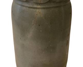 211 - Stoneware Crock 10"x6.5" (Description): Stoneware crock measuring 10 inches tall by  6.5 inches in diameter. Sold as-is with  crack.