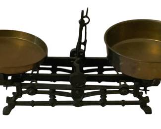 238 - Antique Scale 8"x17"x6.5" (Description): Antique balance scale featuring a cast iron  base with decorative openwork design and two  brass weighing pans. Measures 8 inches by 17  inches by 6.5 inches.