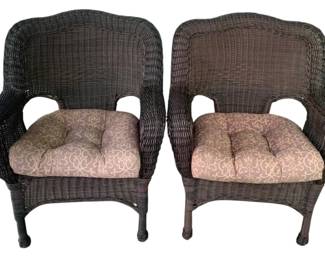 8 - 2 Wicker Chairs w/ cushions 34"x29"x29" (Description): A 2-piece set of wicker chairs featuring  curved backs and armrests. Each chair  includes a tufted seat cushion. Measures 34  inches by 29 inches by 29 inches.