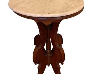 134 - Marble Top Table 27"x20"x16" (Description): A marble top table featuring a round marble  surface set upon a carved wooden pedestal  base with four decorative scrolled legs.  Measures 27 inches high by 20 inches wide by  16 inches deep.