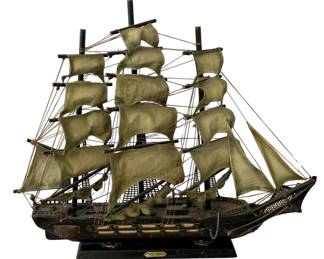 89 - Model Ship 21"x24"x5" (Description): Model ship featuring detailed rigging and  multiple sails. Mounted on a display base  with nameplate. Measures 21 inches by 24  inches by 5 inches.