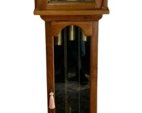 715 - Ridgeway Grandfather Clock 76"x18"x11" (Description): Ridgeway grandfather clock featuring a  classic design with a wood case. The clock  includes decorative brass accents on the dial  face and visible pendulum and weights behind  the glass door panel. Measures 76 inches tall by 18 inches wide by 11 inches deep. Used as is electric/electronic/mechanical  item. No guarantee all components, untested.