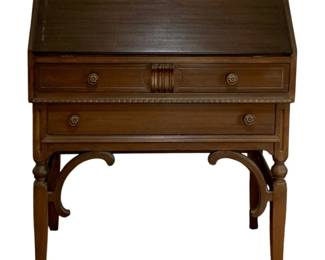 714 - Skandia Slant Front Desk 30.5"x30.5"x15.5" (Description): Skandia slant front desk featuring a  drop-down writing surface with a keyhole  escutcheon, two drawers with decorative  rosette hardware, carved center medallion,  and dentil molding detail. The desk is supported by turned legs with curved brackets  and splayed feet. Measures 30.5 inches high  by 30.5 inches wide by 15.5 inches deep.