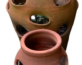 20 - 2 Terra Cotta Strawberry Planters (Description): Two terra cotta strawberry planters featuring  multiple planting pockets around the sides  for growing strawberries or herbs. The larger  planter measures 17 inches by 11 inches,  while the smaller planter measures 11 inches by 8 inches.