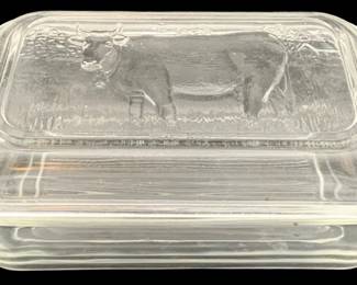 328 - "Cow" Refrigerator Dish 3"x6.5"x4.25" (Description): A clear glass refrigerator dish featuring a  molded cow design on the lid. The dish  measures 3 inches by 6.5 inches by 4.25  inches.