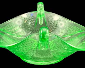 326 - Uranium Green Glass Swan Dish 3.25"x7"x7.5" (Description): Uranium glass swan dish featuring a  decorative swan figure. The piece measures 3  1/4 inches by 7 inches by 7.5 inches.