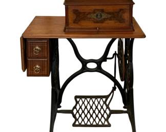 610 - Singer Sewing Machine s/n 6422367 (Description): Antique Singer sewing machine featuring a  wooden cabinet with decorative inlay on the  cover, two side drawers with brass ring  pulls, and a cast iron treadle base with  ornate scrollwork and foot pedal. Measures 39.5 inches high by 30 inches wide by 16  inches deep. Used as is electric/electronic/mechanical  item. No guarantee all components, untested.