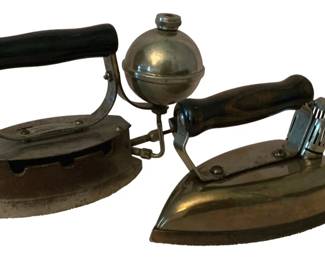 180 - 2 Vintage Irons (Description): A pair of vintage irons. This lot includes  two antique pressing irons with wooden  handles, showcasing different styles of early  ironing technology.