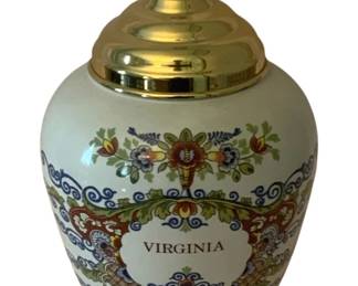 171 - Delft Virginia Ginger Jar 7.5"x5" (Description): Delft Virginia ginger jar featuring  traditional polychrome floral decoration with  a brass lid. The jar displays the word  "Virginia" on a decorative cartouche.  Measures 7 1/2 inches tall by 5 inches wide.