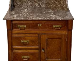 771 - Marble Top Washstand 39"x30"x16.5" (Description): Marble top washstand featuring a variegated  marble surface with a raised back splash. The  wooden cabinet base includes one full-width  drawer at the top, two smaller drawers on the  left side, and a single door cabinet on the right. Fitted with brass bail pulls and a  keyhole escutcheon. Measures 39 inches high  by 30 inches wide by 16.5 inches deep.