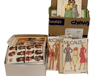 720 - Assorted Vintage Sewing Patterns (Description): A lot of vintage sewing patterns including  brands such as Simplicity and McCall's. The  collection features various clothing patterns  from different eras.