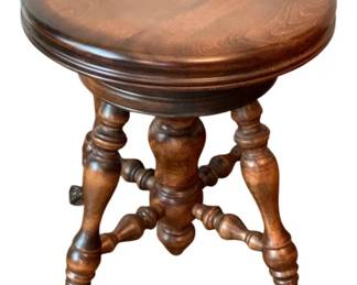 63 - Wood Stool 18"x14.5" (Description): A wooden stool featuring turned legs with  claw feet and a round seat. Measures 18  inches by 14.5 inches.