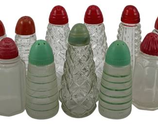 521 - Assorted Salt & Pepper Shakers 4" (Description): A lot of salt and pepper shakers in various  pressed glass patterns with plastic screw-on  tops in red and green. Measures 4 inches  tall.