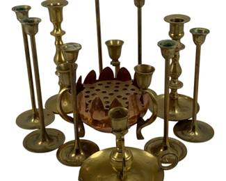 456 - Assorted Brass Candleholders (Description): A lot of brass candleholders in assorted  styles and sizes. The collection includes  various tall taper candlesticks, a  chamberstick with ring handle, and a copper  flower frog. The pieces display traditional brass construction suitable for home decor.