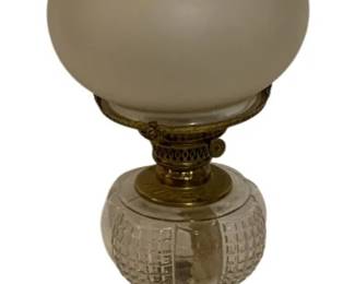 733 - Oil Lamp 21" (Description): Oil lamp measuring 21 inches in height.  Features a frosted glass globe shade with  clear glass chimney, cut glass font, ornate  brass fittings with decorative foliate  motifs, and a square black base.