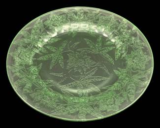 532 - Uranium Green Glass Plate 9" (Description): Uranium glass plate measuring 9 inches in  diameter. The glass exhibits the  characteristic green coloration associated  with uranium glass.