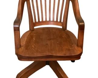 109 - Office Wood Chair w/ casters 33"x22"x25" (Description): Wooden rolling chair featuring a slatted back  design and curved arms. The chair sits on a  four-leg base with casters for easy mobility.  Measures 33 inches high by 22 inches wide by  25 inches deep.