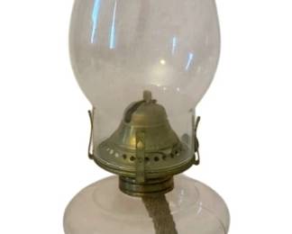 208 - Oil Lamp 14" (Description): Oil lamp measuring 14 inches in height.  Features a clear glass chimney, brass burner  with wick, glass font with finger loop  handle, and round pedestal base.