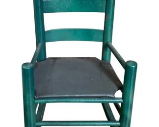 33 - Painted Wood Child's Rocker 23"x15"x21" (Description): Painted wood rocking chair featuring a ladder  back design with turned finials and  armrests. The chair has a solid seat and  curved rockers. Measures 23 inches by 15  inches by 21 inches.