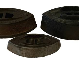 188 - 3 Cast Iron Bases (Description): A lot of three cast iron bases. These sturdy  pieces feature characteristic cast iron  construction and appear to be designed to  serve as bases or stands.