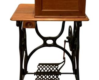 698 - Singer Sewing Machine 25.5"x16"x38.5" (Description): S/N - 994555 / 788555 - Singer sewing machine  featuring a wooden case with hinged lid,  mounted on a cast iron treadle base with foot  pedal and wheel mechanism. Measures 25.5  inches by 16 inches by 38.5 inches. Used as is electric/electronic/mechanical  item. No guarantee all components, untested.