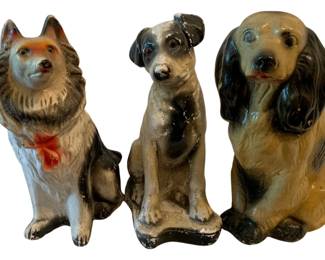 635 - 3 Chalkware Dogs 11.5" (Description): A collection of three chalkware dog  figurines. Each dog is depicted in a seated  position and features hand-painted details.  The tallest measures 11.5 inches.