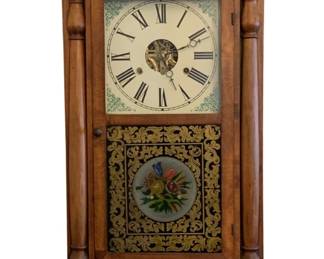 97 - Seth Thomas Mantle Clock 25"x15"x4.5" (Description): Seth Thomas mantle clock featuring a wooden  case with turned column details flanking the  face. The clock displays a painted dial with  Roman numerals and decorative corner accents.  The lower glass panel features an ornate reverse-painted floral design with gold  scrollwork border. Measures 25 inches high by  15 inches wide by 4.5 inches deep.