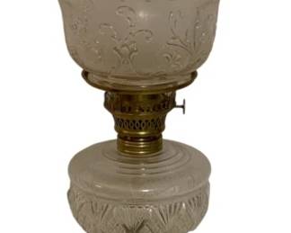 792 - Oil Lamp 23" (Description): Oil lamp measuring 23 inches in height.  Features a clear glass chimney, frosted  decorative glass shade with embossed floral  pattern, pressed glass font, and a porcelain  stem decorated with a floral bouquet, mounted on a black base.