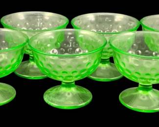 383 - 6 Uranium Green Glass Footed Sherbets (Description): Set of six uranium glass goblets featuring a  bubble or hobnail pattern. Each goblet  measures 3.25 inches in diameter by 3.5  inches tall. Sold as is - minor chipping