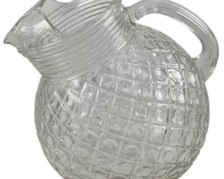 221 - Glass Ball Pitcher 8"x9"x7" (Description): Glass pitcher featuring a spherical body with  textured grid pattern and ribbed neck with  pour spout. Measures 8 inches by 9 inches by  7 inches.