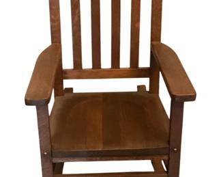 146 - Small Wood Rocker 26"x17"x23" (Description): Wooden rocking chair featuring a classic  slatted back design with flat armrests and a  solid wood seat. Measures 26 inches tall by  17 inches wide by 23 inches deep.