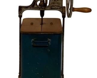 760 - Antique Dexter Butter Churn Model 3303 (Description): Antique Dexter Churn, Model 3303. This  hand-crank butter churn features a cast iron  frame with a wheel mechanism, wooden handle,  and a blue enameled metal container. Measures  25 inches tall by 11 inches wide by 10 inches deep. Used as is electric/electronic/mechanical  item. No guarantee all components, untested.