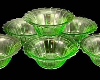 327 - 6 Uranium Green Glass Bowls 2"x5.25" (Description): 6 uranium glass bowls. Each bowl measures 2  inches tall by 5.25 inches in diameter. The  bowls feature a ribbed pattern with scalloped  edges, characteristic of vintage uranium  glass which glows under UV light.