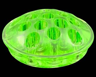 340 - Uranium Green Glass Frog 1.5"x4" (Description): Uranium glass frog, a vintage flower  arranging accessory designed to hold stems in  place within a vase or bowl. The piece  exhibits the characteristic bright green glow  of uranium glass. Measures 1 1/2 inches tall by 4 inches in diameter.