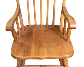 34 - Child's Wood Rocker 27"x16"x22" (Description): Wooden rocking chair with spindle back design  and curved armrests. Features turned legs  and stretchers with a contoured seat.  Measures 27 inches tall by 16 inches wide by  22 inches deep.