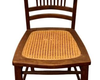 689 - Antique Chair 34.5"x15.5"x16" (Description): Antique chair featuring a spindle back design  and cane seat. Measures 34.5 inches high by  15.5 inches wide by 16 inches deep.
