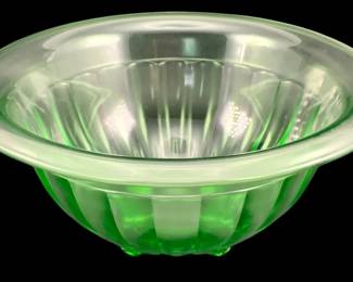 394 - Uranium Green Glass Mixing Bowl 4"x9.5" (Description): Uranium glass mixing bowl featuring a ribbed  design. The bowl measures 4 inches in height  by 9.5 inches in diameter.