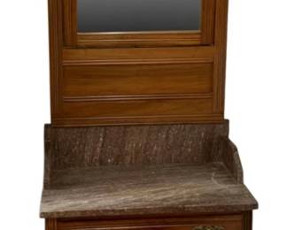 716 - Antique Victorian Eastlake Washstand w/ marble top (Description): Marble-top dresser with attached swivel  beveled mirror. The piece features a carved  decorative crest, rectangular mirror, marble  top surface with raised back splash, two  drawers with brass bail handles, and a lower cabinet with double paneled doors. The  dresser rests on casters. Measures 80 inches  high by 29.5 inches wide by 16 inches deep.