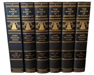 101 - 6 March of Democracy Book Set James Adams (Description): A six-piece set of The March of Democracy  books by James Truslow Adams, published by  Scribners. This comprehensive historical  series features navy blue bindings with gold  gilt lettering and decorative Liberty Bell motifs on the spines.