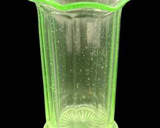 325 - Uranium Green Glass Vase 5.5"x3.5" (Description): Uranium glass vase featuring a scalloped rim  and vertical ribbed design with a decorative  sunburst pattern at the base. Measures 5 1/2  inches tall by 3.5 inches in diameter.