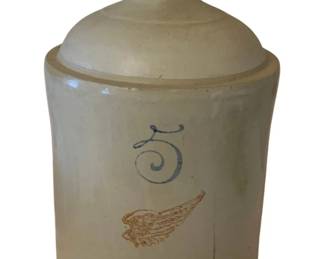218 - 5 Gallon Red Wing Stoneware Jug 19"x11" (Description): A 5 gallon Red Wing stoneware jug featuring  the iconic red wing logo. This piece shows  its age and is sold as-is. Measures 19 inches  tall by 11 inches in diameter.