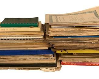 117 - Assorted Music Books & Sheet Music (Description): A lot of music books, including various  titles and styles. The collection features an  assortment of sheet music and instructional  materials in various conditions, with both  softcover and hardcover bindings represented.