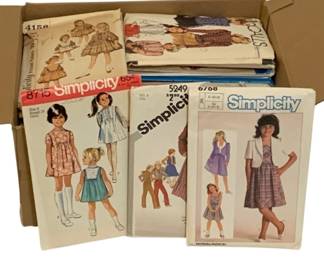723 - Assorted Sewing Patterns (Description): A lot of sewing patterns. The collection  includes various patterns from brands such as  Simplicity and McCall's, featuring  children's clothing designs.