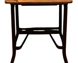 680 - Antique Table 25"x17.5"x14" (Description): Antique table featuring a wooden top on a  metal base with casters. Measures 25 inches  tall by 17.5 inches wide by 14 inches deep.
